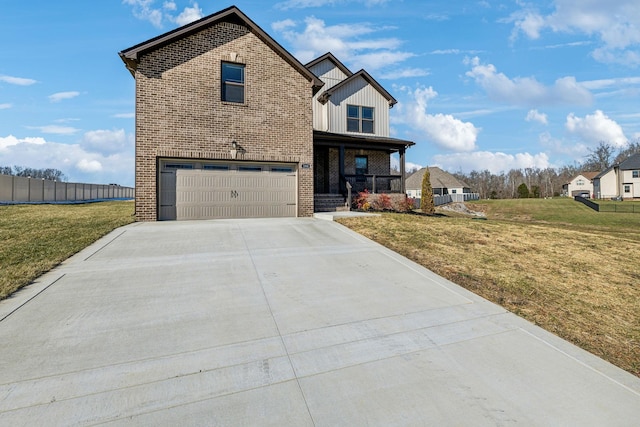 front of property featuring covered porch, a garage, and a front lawn