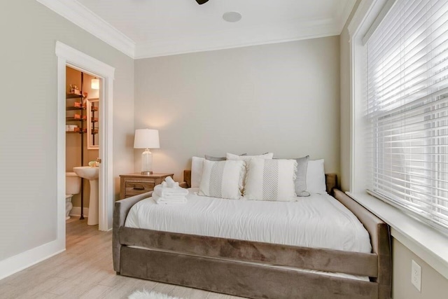 bedroom with ensuite bathroom, ornamental molding, and light hardwood / wood-style flooring