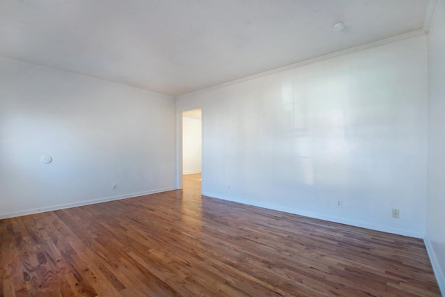 empty room featuring dark hardwood / wood-style flooring and crown molding