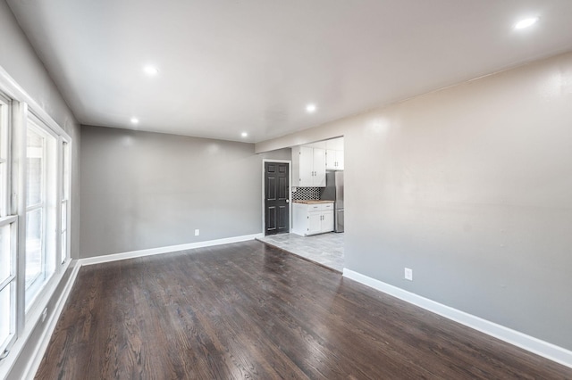 unfurnished living room featuring hardwood / wood-style flooring