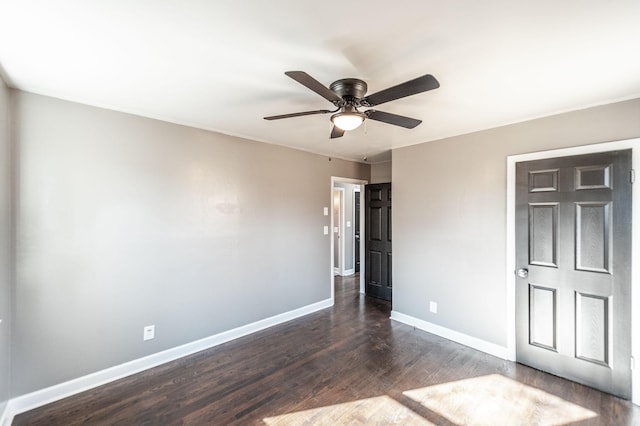 unfurnished bedroom with ceiling fan and dark hardwood / wood-style floors