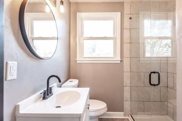 bathroom featuring vanity, an enclosed shower, plenty of natural light, and toilet