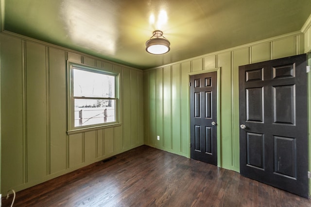 unfurnished bedroom featuring dark hardwood / wood-style floors