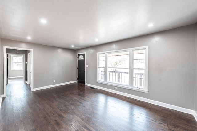 interior space with dark wood-type flooring and a wealth of natural light