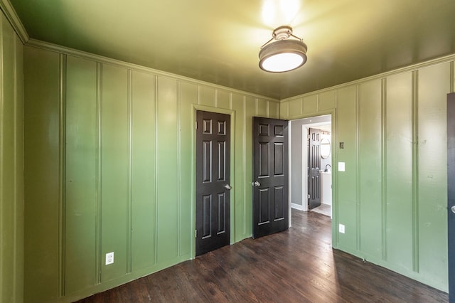 unfurnished bedroom with dark hardwood / wood-style flooring