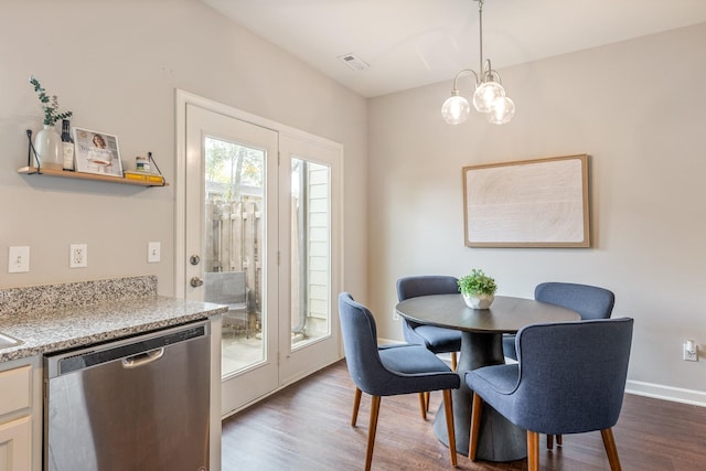 dining space featuring an inviting chandelier and wood-type flooring