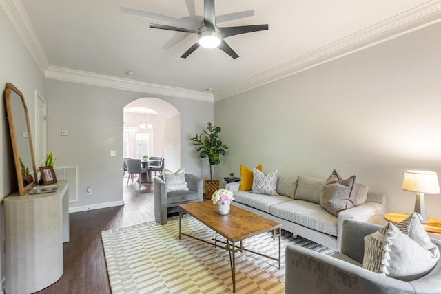 living room with crown molding, ceiling fan, and dark hardwood / wood-style flooring