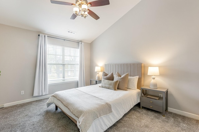 carpeted bedroom with ceiling fan and vaulted ceiling