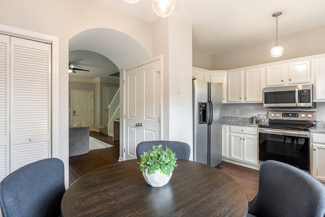 dining space featuring ceiling fan and dark hardwood / wood-style flooring