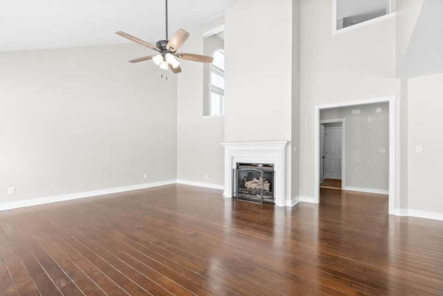 unfurnished living room with high vaulted ceiling, ceiling fan, and dark hardwood / wood-style flooring