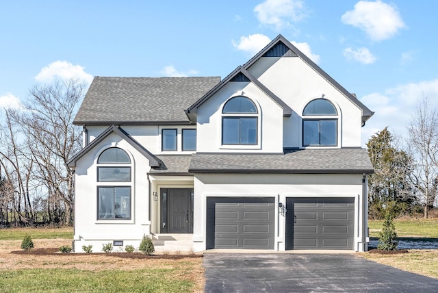 front facade with a garage and a front yard