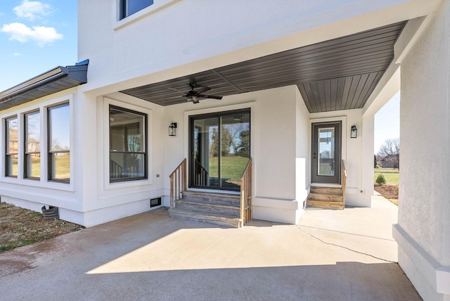 entrance to property with ceiling fan and a patio