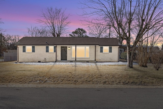 ranch-style home with a yard