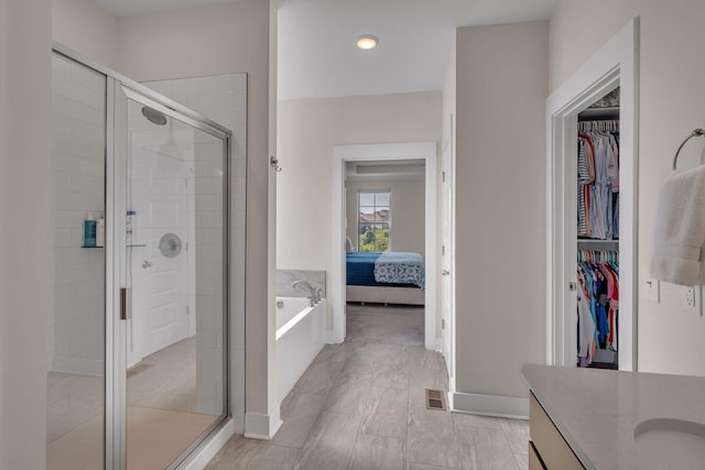 bathroom featuring vanity and separate shower and tub