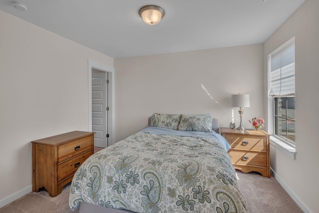 carpeted bedroom featuring multiple windows