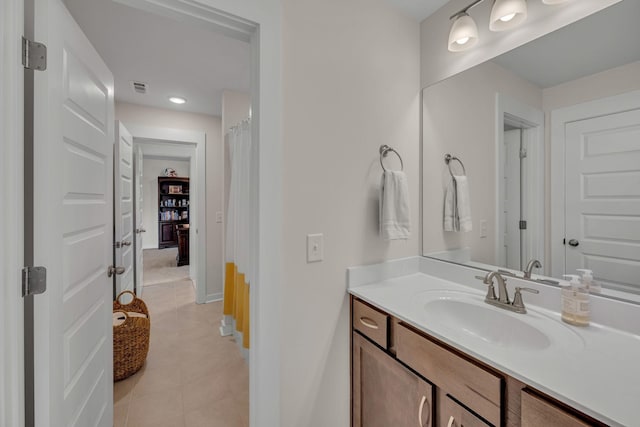 bathroom featuring tile patterned flooring and vanity