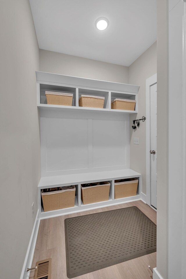 mudroom with light hardwood / wood-style floors