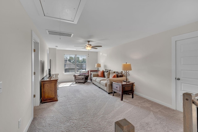 carpeted living room with ceiling fan