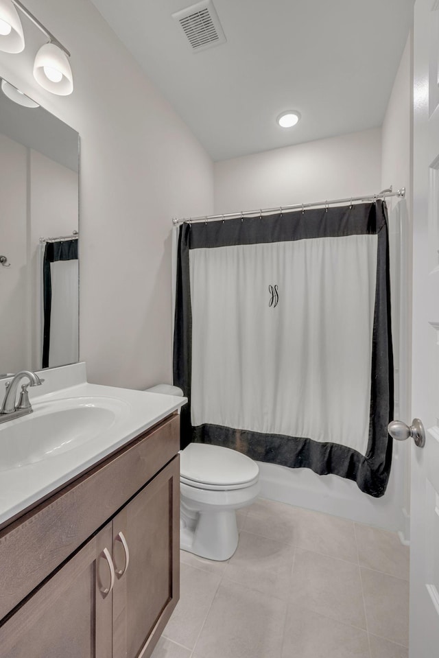 full bathroom featuring shower / bathtub combination with curtain, tile patterned flooring, vanity, and toilet