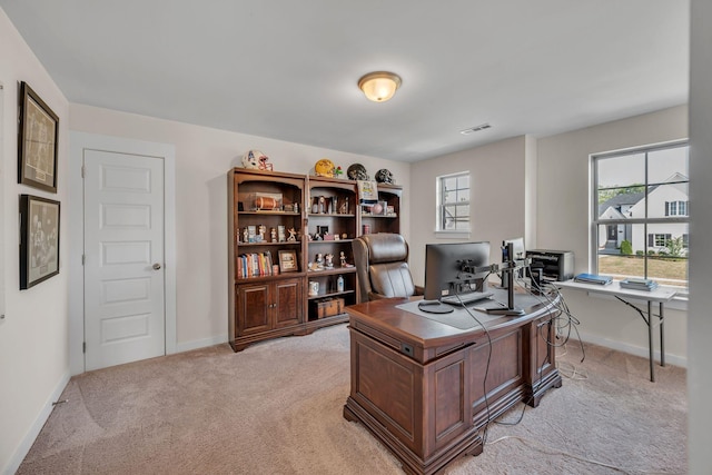 office area with plenty of natural light and light colored carpet