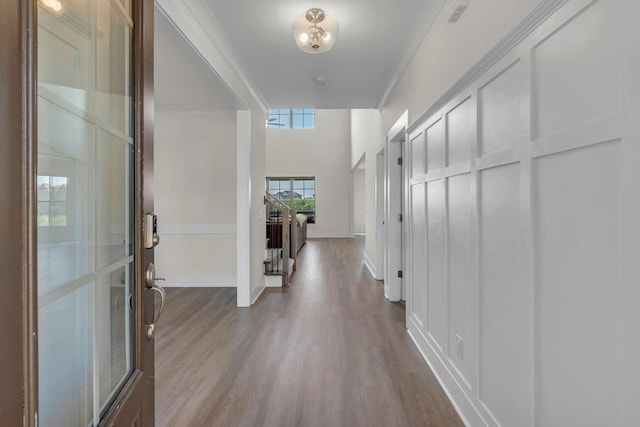 entryway with crown molding and wood-type flooring