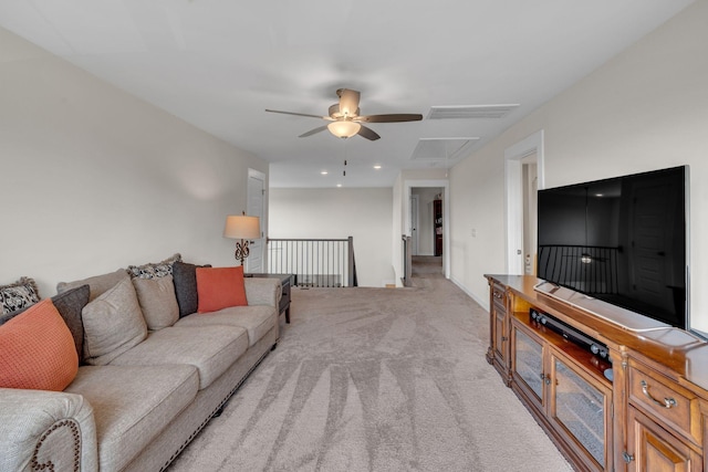 carpeted living room with ceiling fan