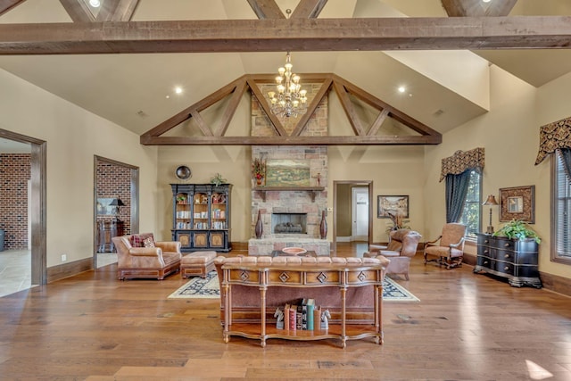 living room featuring a fireplace, a chandelier, high vaulted ceiling, and hardwood / wood-style flooring