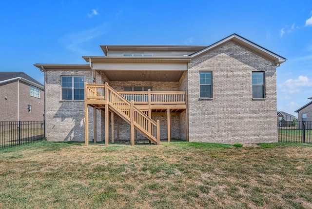 rear view of property with a yard and a deck