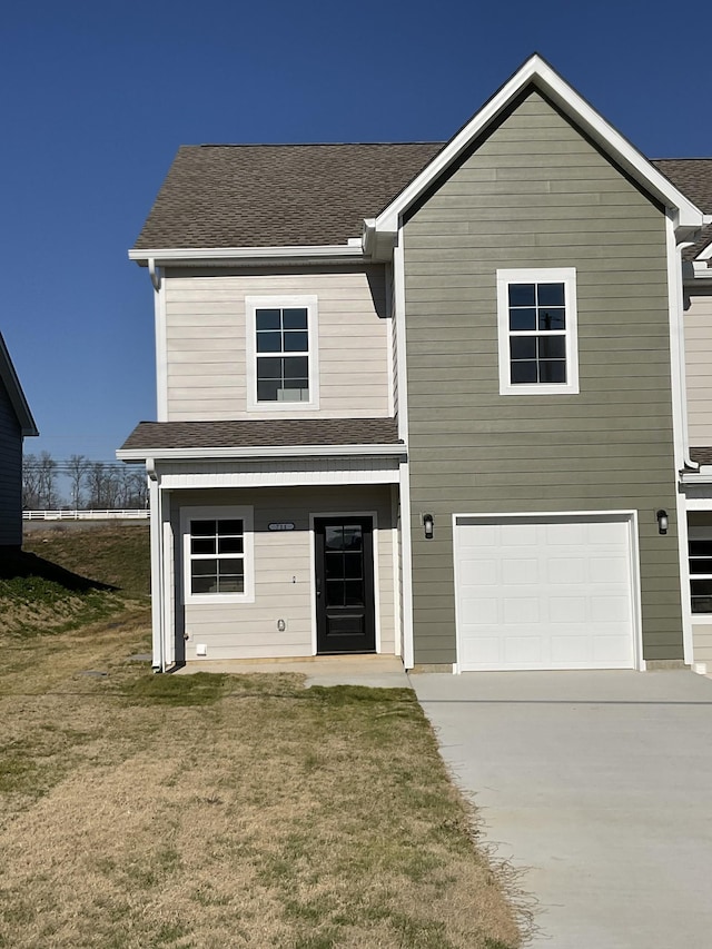 view of front of house featuring a front yard and a garage