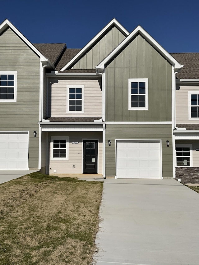 view of front of property with a front yard and a garage