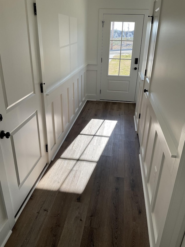 doorway with dark wood-type flooring