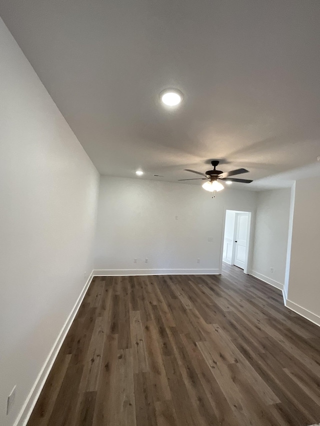 spare room featuring ceiling fan and dark hardwood / wood-style flooring