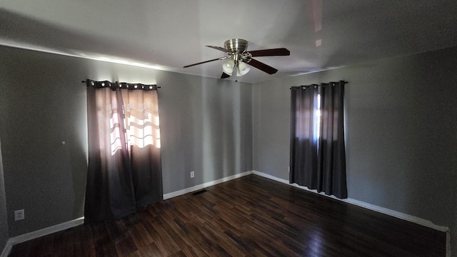 spare room featuring dark hardwood / wood-style flooring and ceiling fan