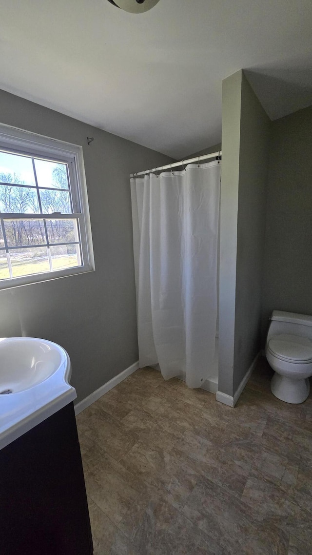 bathroom featuring vanity, toilet, and curtained shower