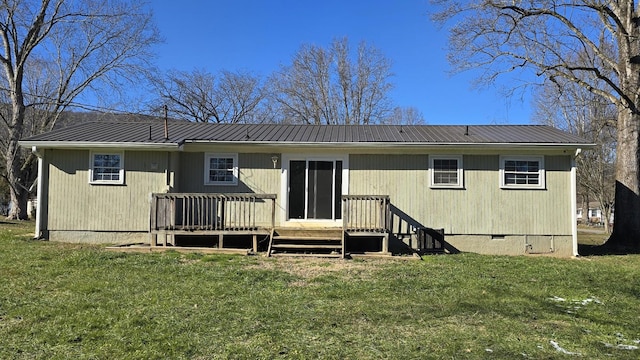 rear view of house featuring a lawn and a wooden deck