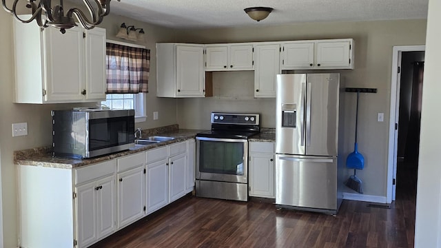 kitchen featuring stainless steel appliances and white cabinetry