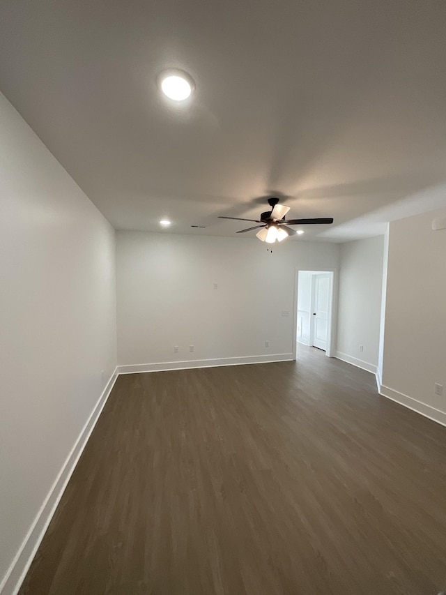 spare room with dark hardwood / wood-style floors and ceiling fan