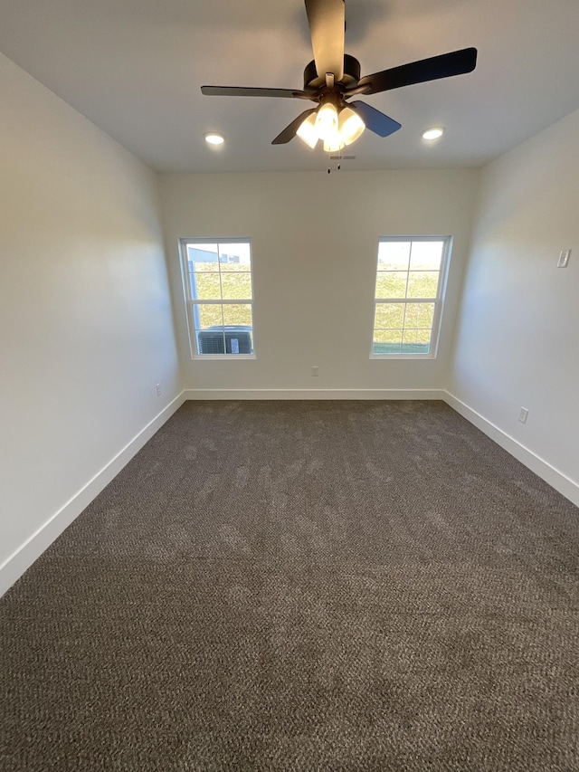 carpeted spare room featuring ceiling fan