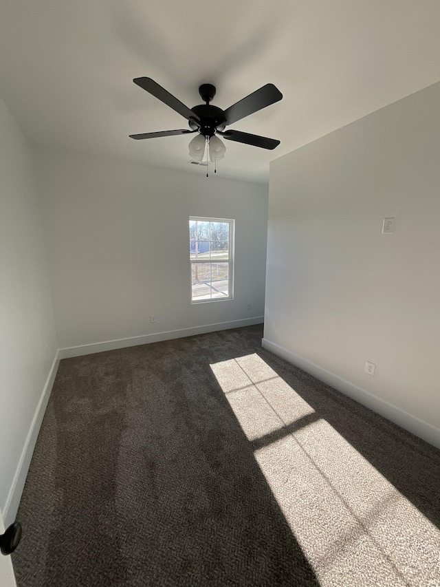 unfurnished room featuring ceiling fan and dark carpet