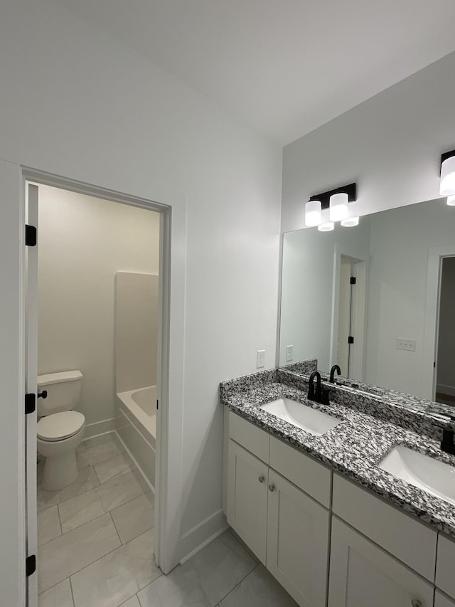 bathroom featuring vanity and toilet