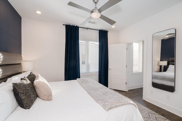 bedroom with ceiling fan and dark hardwood / wood-style flooring