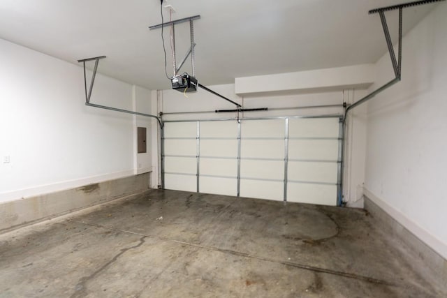 garage featuring electric panel and a garage door opener