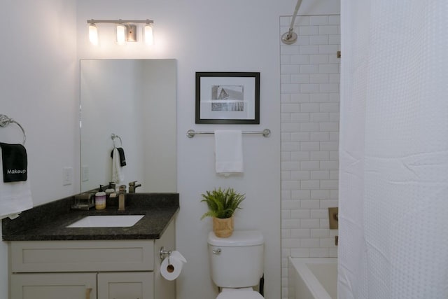 full bathroom with shower / bath combo, vanity, and toilet