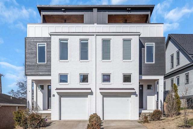 view of front of house featuring a balcony, board and batten siding, concrete driveway, an attached garage, and brick siding