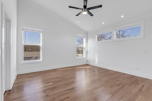 unfurnished room featuring baseboards, lofted ceiling, and wood finished floors