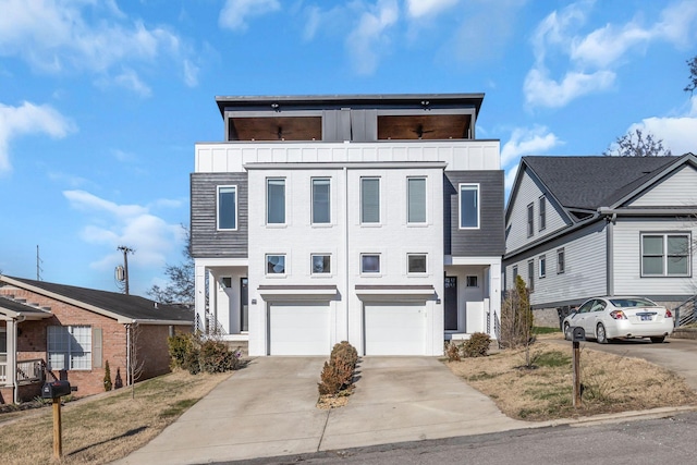 view of front of house with an attached garage, board and batten siding, and driveway