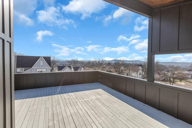 wooden deck with a residential view and a mountain view