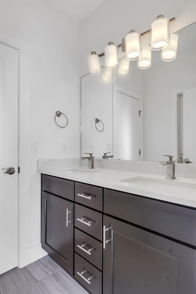 full bathroom with a sink and double vanity