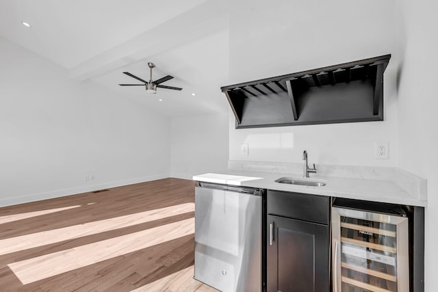 bar with beverage cooler, baseboards, a sink, dishwasher, and light wood-type flooring