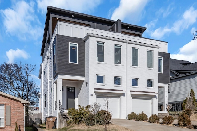 view of front facade featuring brick siding, board and batten siding, concrete driveway, and a garage